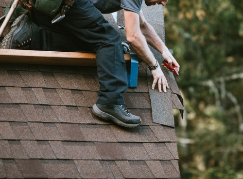 A contractor re-roofing a home in Champaign IL