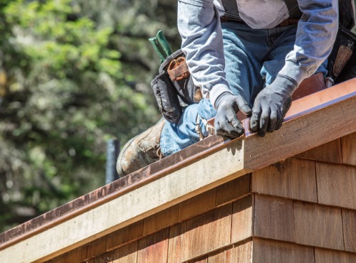 A roofer performing flashing repair in Central Illinois