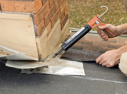 A contractor working on Chimney Flashing and Repair for a Champaign IL home