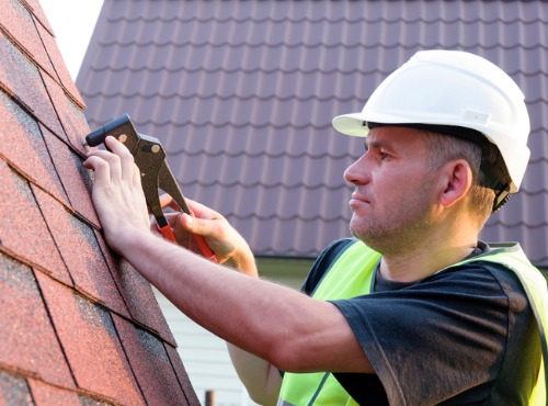 Close up of a Man Repairing Roofing near Champaign
