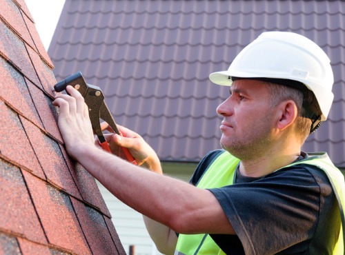 Close up of a Man Repairing Roofing near Champaign