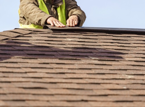 Contractor finishing the installation of Residential Roofing in Champaign IL