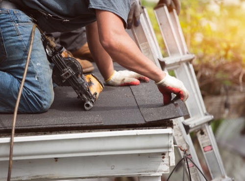 Roofing Contractors in Central Illinois repairing the edge of a roof