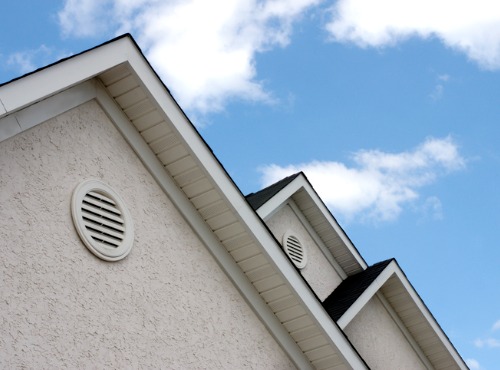 A sloped roof with a circular vent for attic ventilation systems in Monticello IL