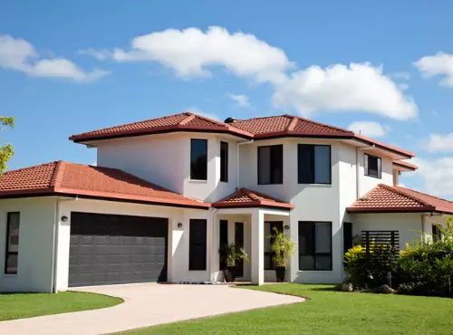 A house is seen with a tile roof. What type of roof do I need? Call Popejoy Roofing.