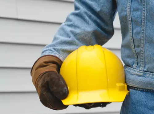 A siding worker is seen on the job. 