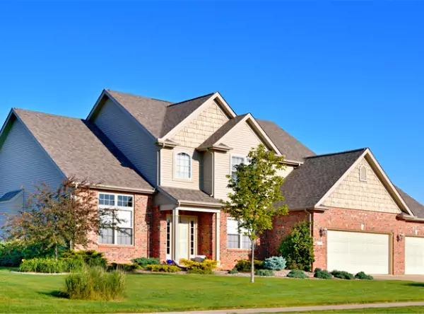 A modern home with new siding and roofing provided by Popejoy, the best Champaign Urbana Roofing Contractor