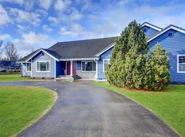 A beautiful blue home with new Malarkey Shingles installed by Popejoy Roofing